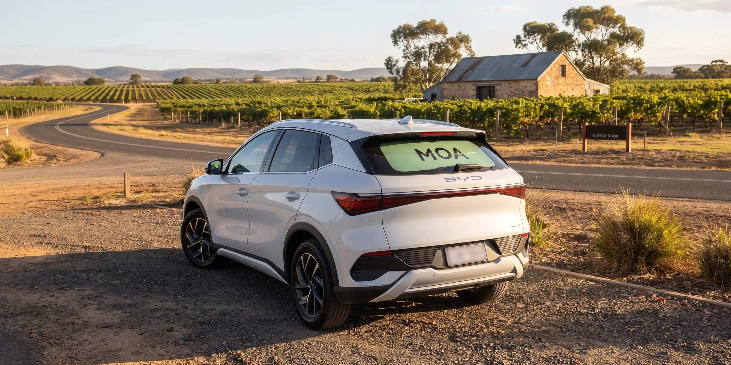 MOA branded electric SUV parked on a country road at golden hour, mint rear window ad visible
